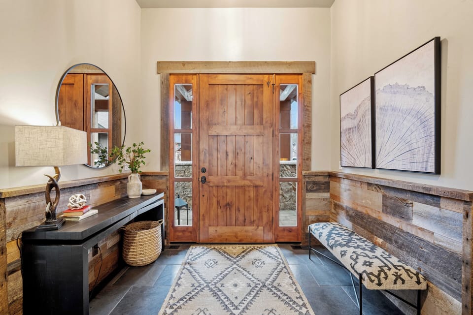 Step into your welcoming entryway where rustic wood meets modern comfort, setting the tone for your mountain retreat.