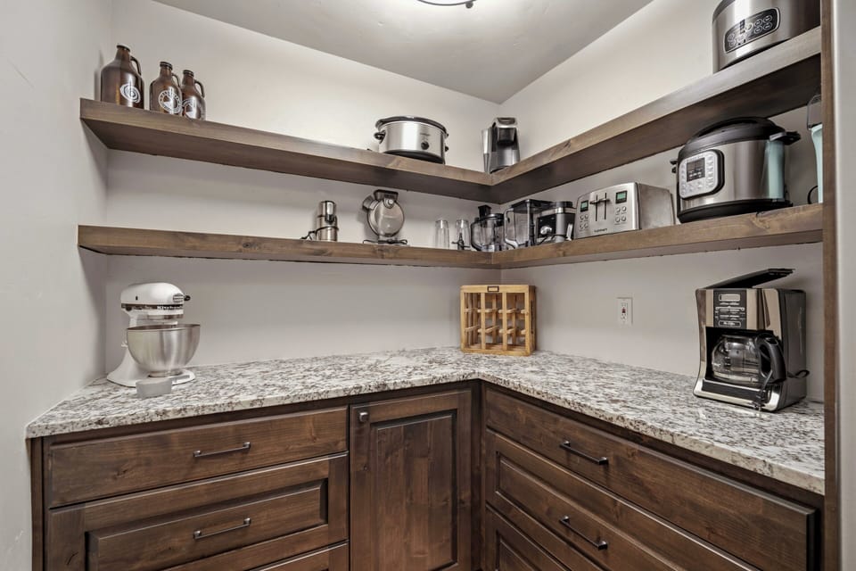 Your fully-equipped pantry awaits with granite counters, rich wood cabinetry, and every appliance needed for memorable meals.