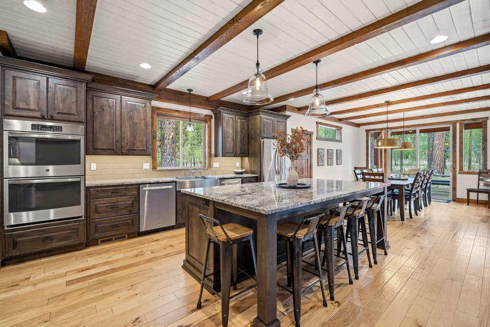 Your spacious kitchen features rustic wood beams, granite counters, and a large island perfect for cooking memorable meals together.