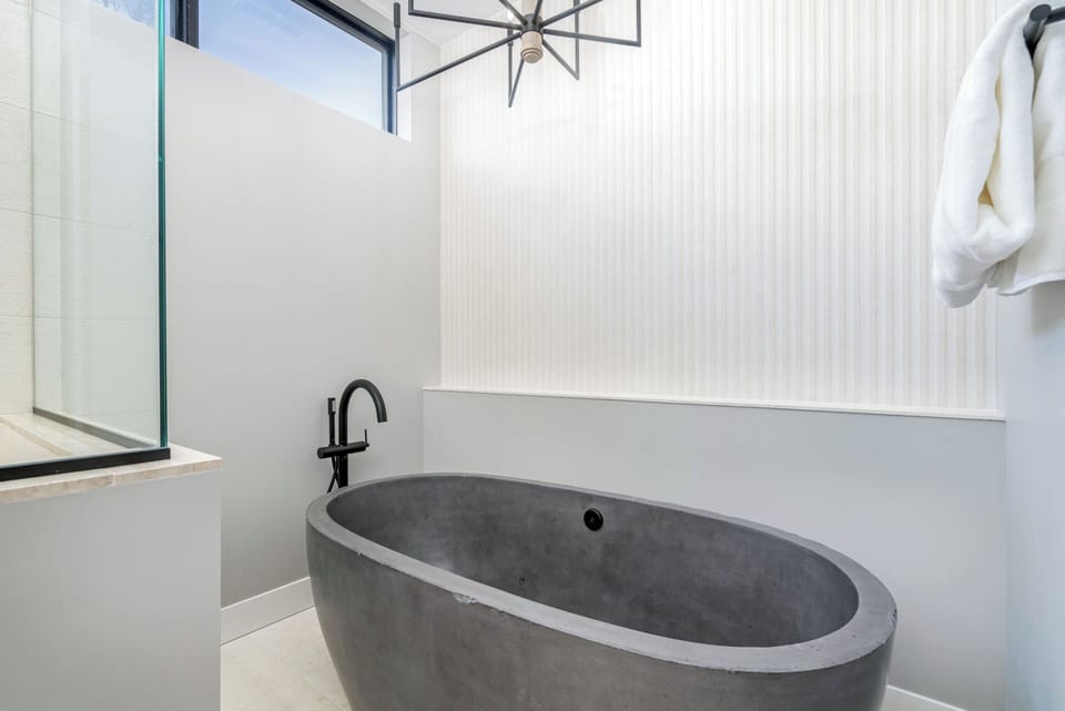 Spacious and elegant bathtub in the primary bathroom.
