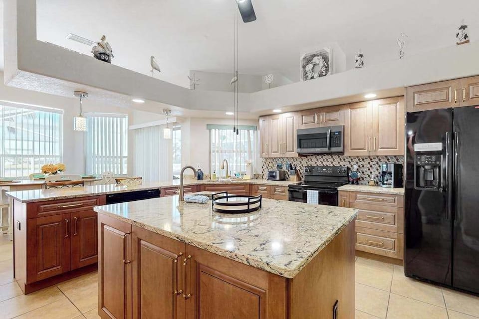 Kitchen includes a starter kit with essentials such as dish soap, detergent, trash bags, toilet paper, and paper towels. Guests are responsible for additional supplies.