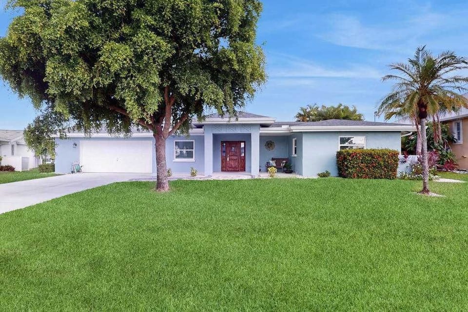 Inviting exterior with a spacious driveway providing convenient parking for up to three vehicles.