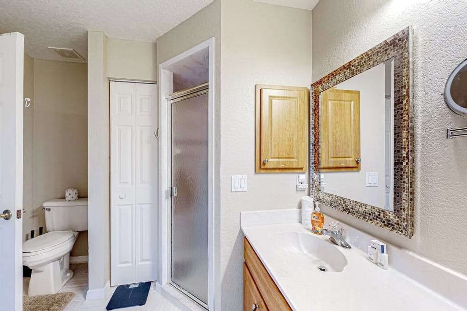 Full primary bathroom featuring a convenient walk-in shower and garden tub. Shampoo, conditioner, and body wash are provided to get your stay started.