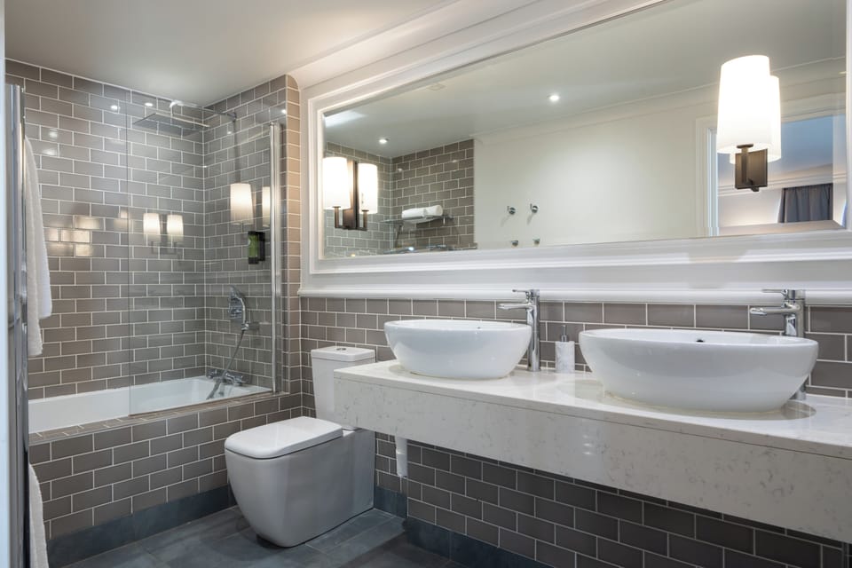 Superior Suite | Bathroom | Hair dryer, slippers, towels, soap
