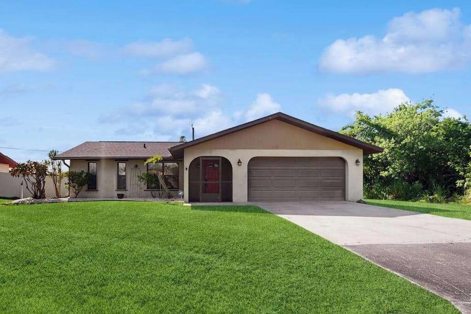 Inviting exterior with a spacious driveway providing convenient parking for up to three vehicles.