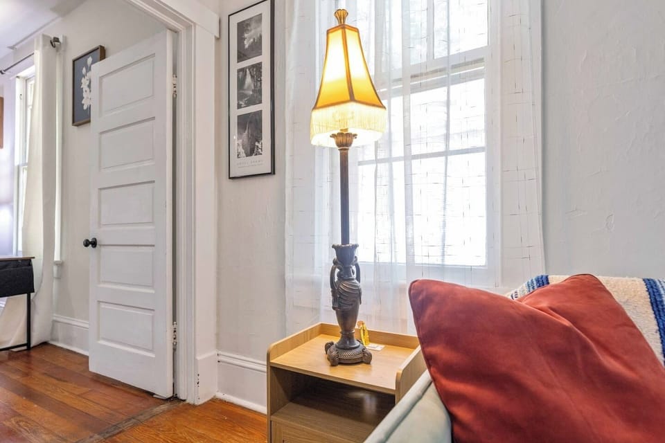 Warm lamplight and soft window light make this corner ideal for a good book or morning coffee, with the master bedroom right around the corner.