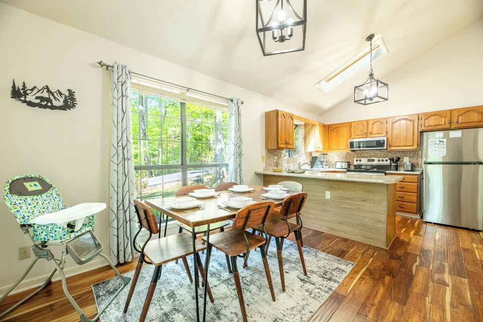 Gather around your dining table for memorable meals with forest views streaming through large windows, creating a warm family atmosphere.