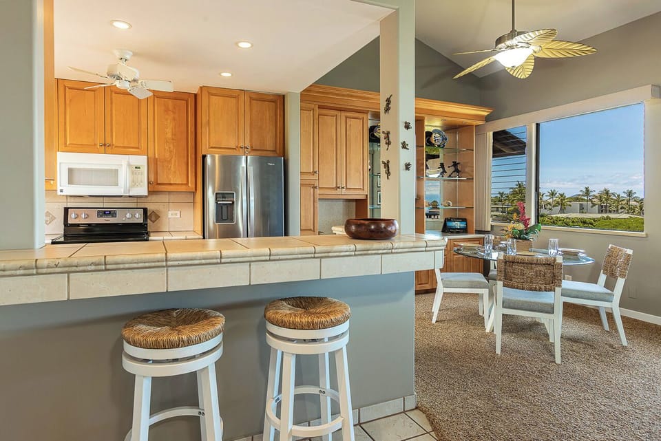 Cook with tropical views past the dining table window.