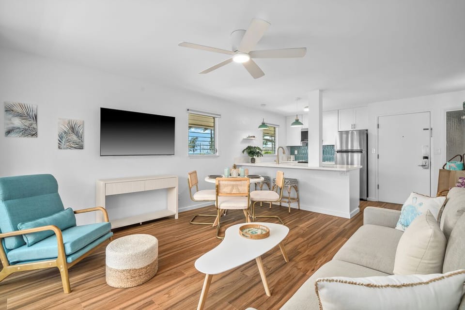 Open living space with coastal-inspired décor, modern kitchen, and dining nook—perfect for unwinding after a day of exploration.