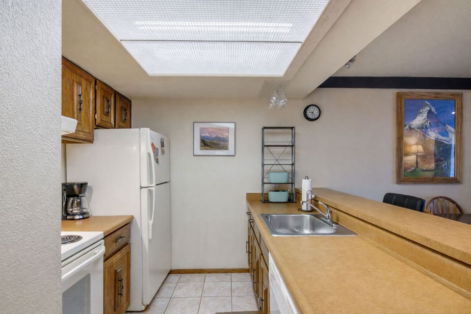 Kitchen with Electric Stove, Oven, Drip Coffee Maker, Dishwasher