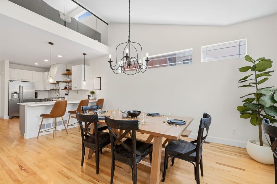 Bright, open-concept space. The modern kitchen and soaring loft above create an airy, inviting atmosphere.