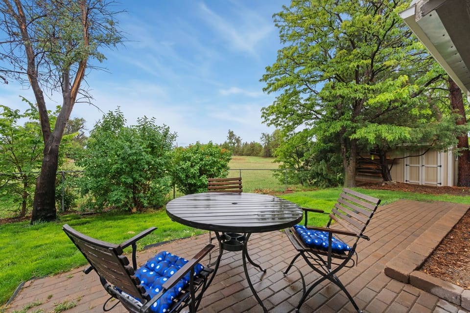Patio overlooks peaceful natural landscapes with lush greenery!