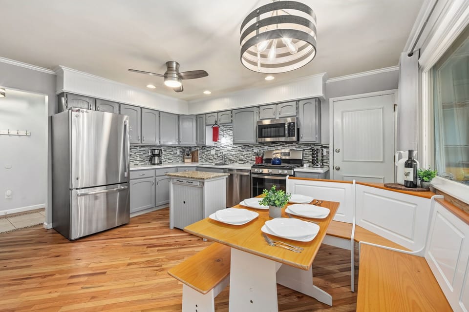 Fully equipped kitchen with modern appliances, ample counter space, and a cozy breakfast nook.