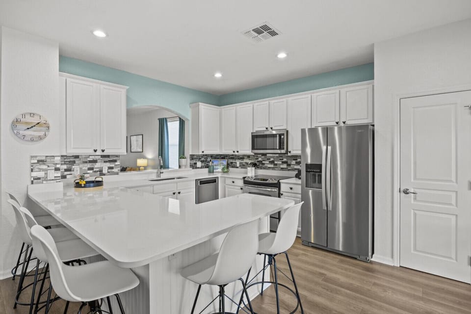 Bright, modern kitchen with a spacious island and bar seating—perfect for gathering and entertaining.