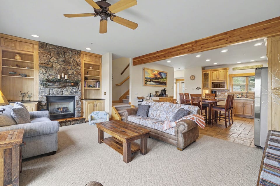 Relax in this inviting living space where rustic charm meets comfort—your perfect retreat with stone fireplace warmth and open mountain views.