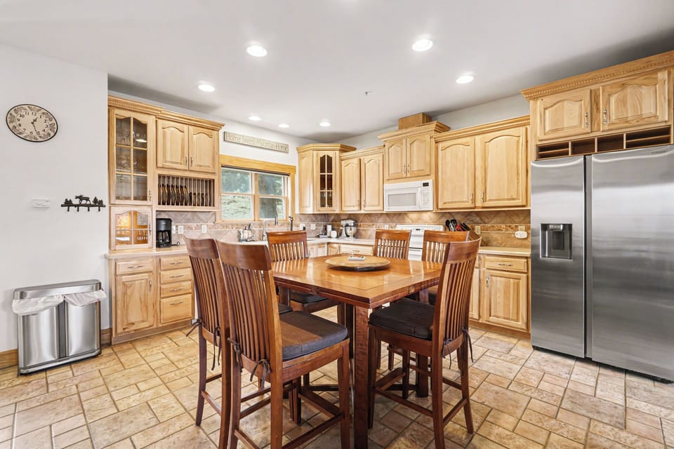 Cook family feasts in your beautiful full kitchen featuring warm wood cabinets, modern appliances, and a spacious dining area perfect for gathering.