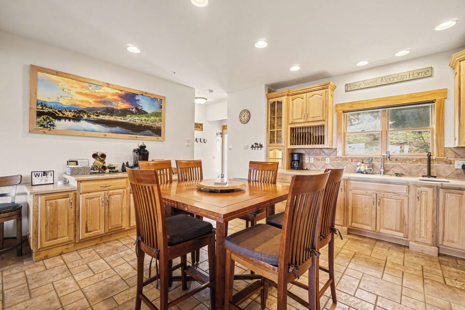 Your spacious kitchen invites memorable meals with warm wood cabinetry, modern appliances, and a cozy dining table perfect for morning coffee or evening gatherings.