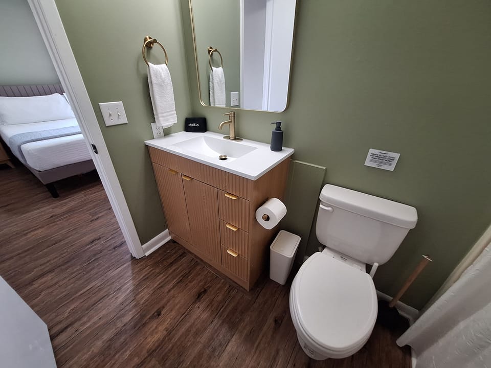 Stylish updated bathroom with modern vanity and warm designer touches