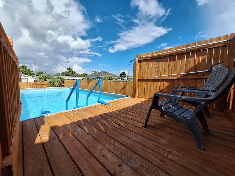 Private pool deck with lounge seating and sunny backyard vibes