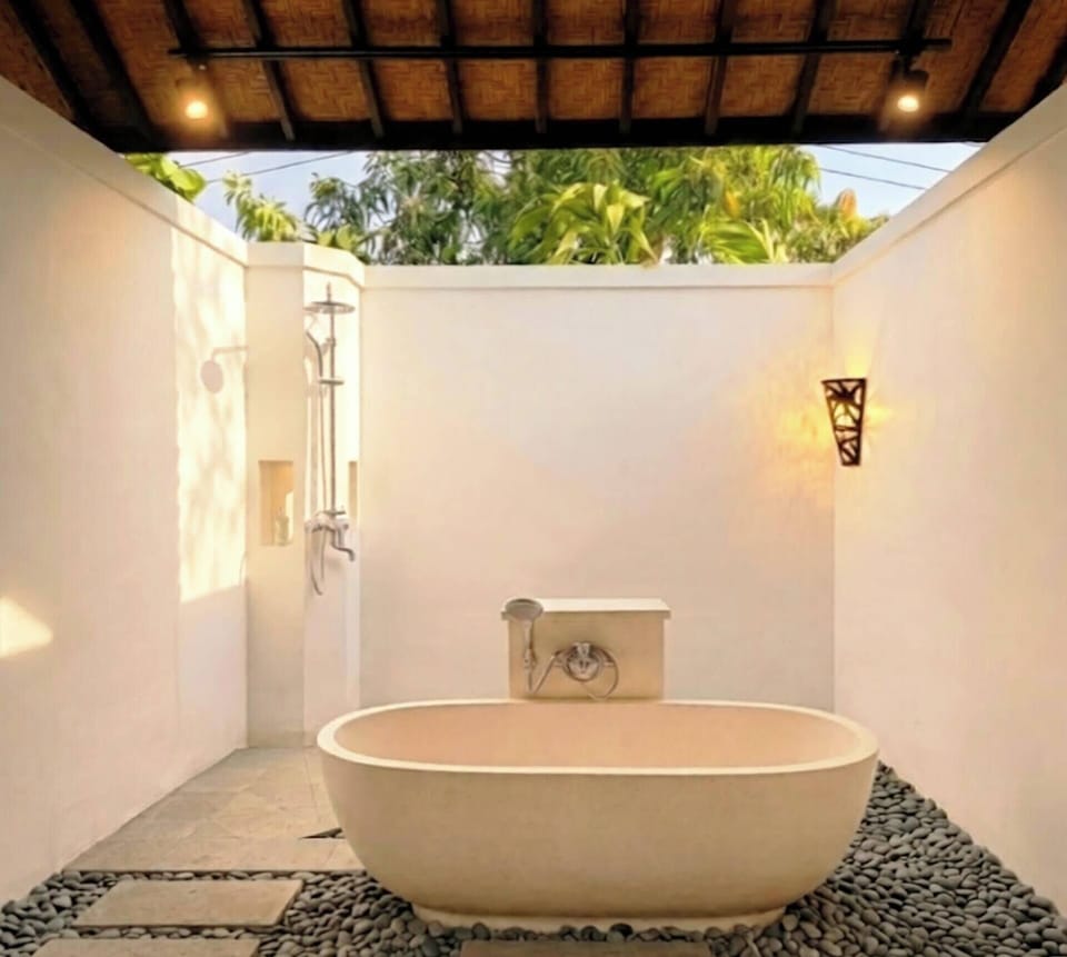 Separate tub and shower, hair dryer, slippers, towels