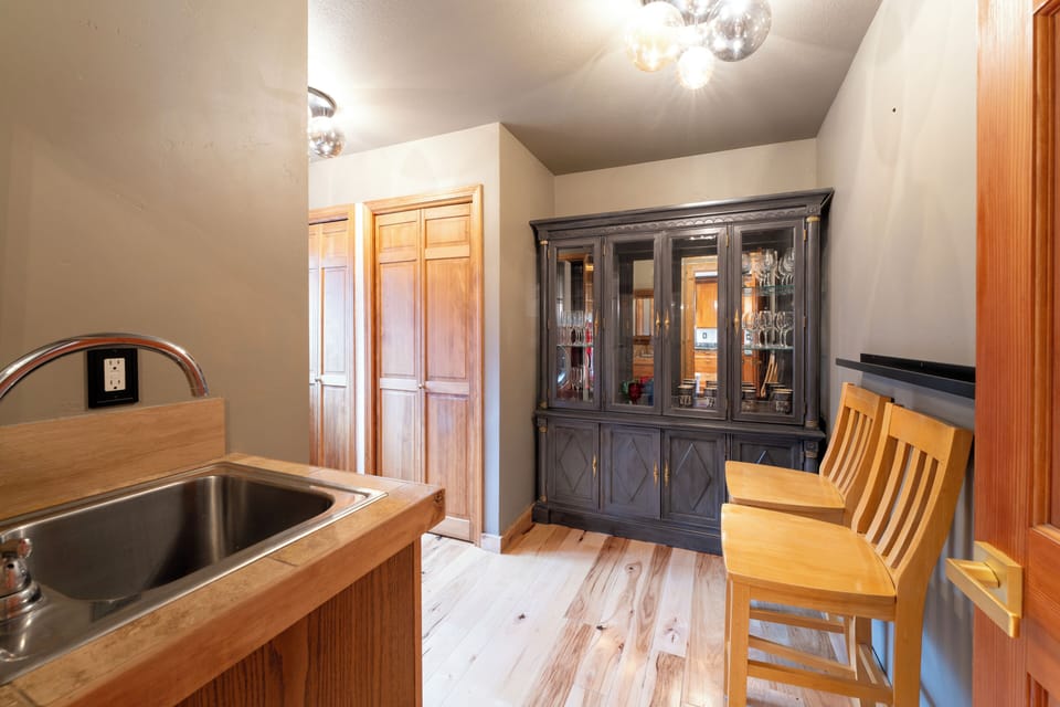 Your charming kitchen combines rustic warmth with elegant touches, featuring rich wood cabinetry and a striking display hutch for memorable meals.