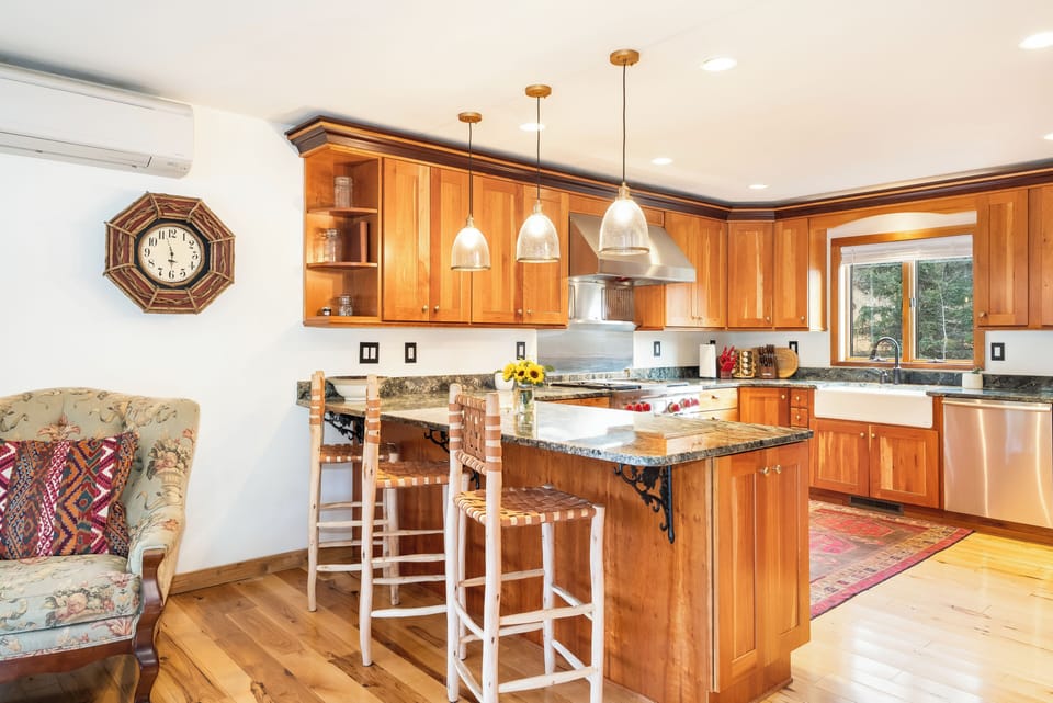 Your dream kitchen awaits with warm wood cabinets, granite countertops, and a cozy breakfast island where you'll savor morning coffee.