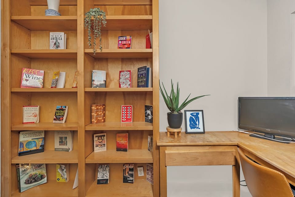 Curl up with a good book from this thoughtfully curated library while enjoying your morning coffee.