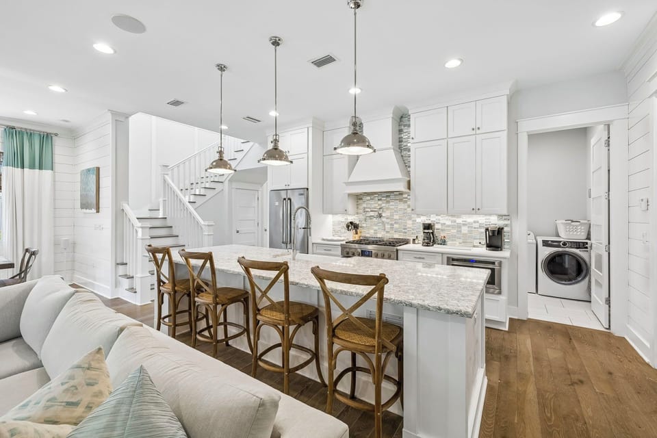 Picture yourself cooking in this bright, modern kitchen with granite countertops and stainless appliances, then gathering with loved ones at the spacious island for meals and memories.