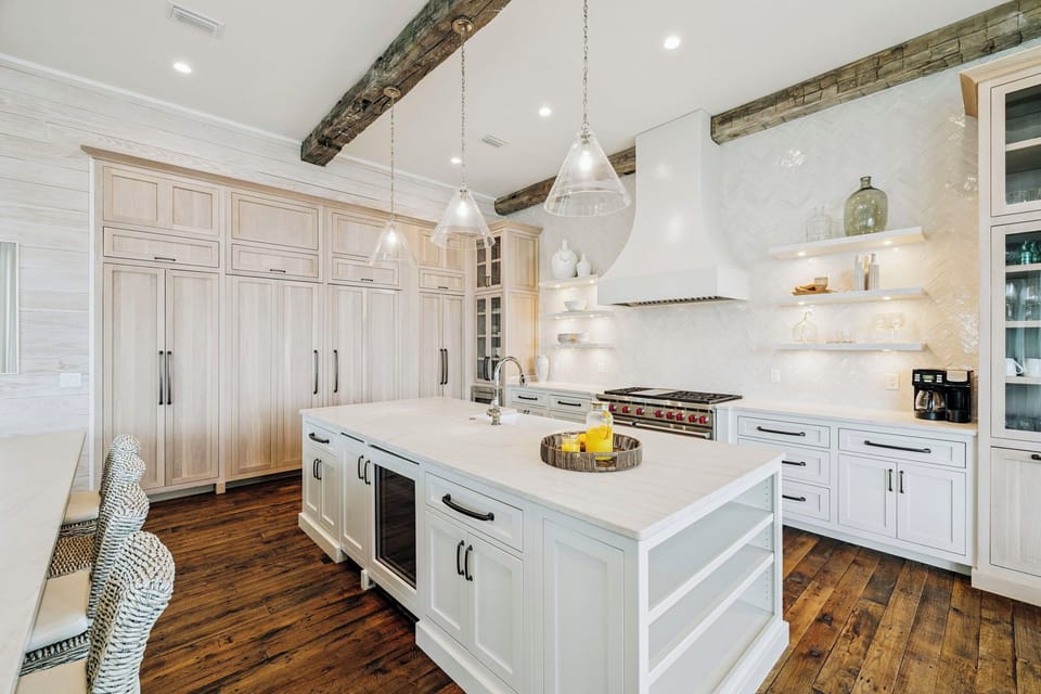 Your gourmet kitchen awaits with marble countertops, professional-grade appliances, and rustic beams overhead for memorable meal preparation.