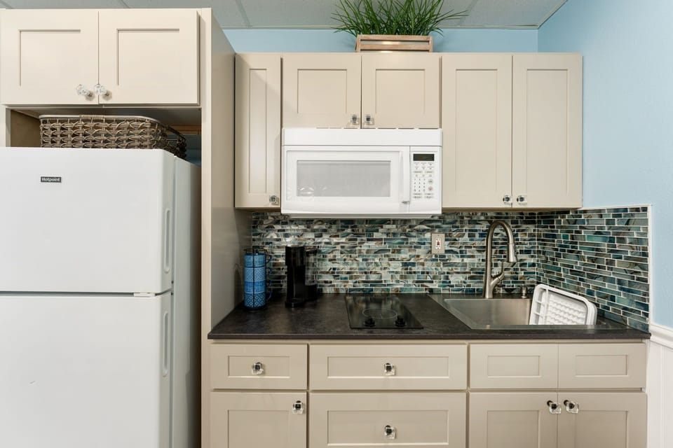 Your fully equipped kitchen features modern appliances and stylish tile backsplash, perfect for preparing meals during your stay.