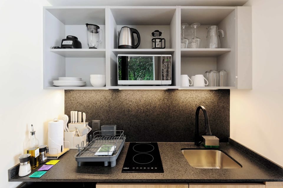 Functional kitchenette with organized storage and cooking area.