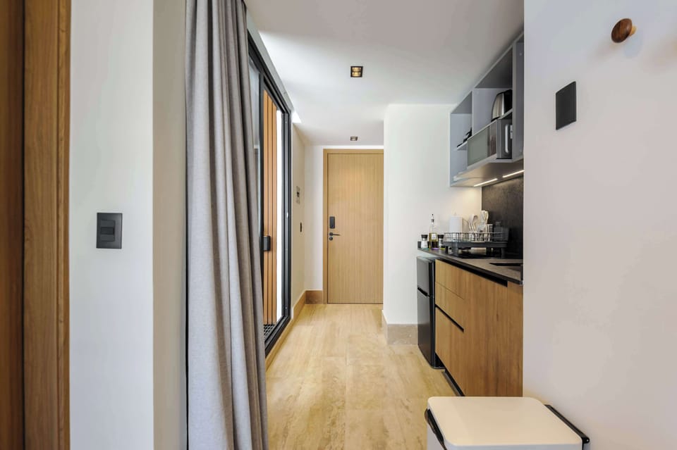 Hallway with a sleek kitchenette and modern finishes.