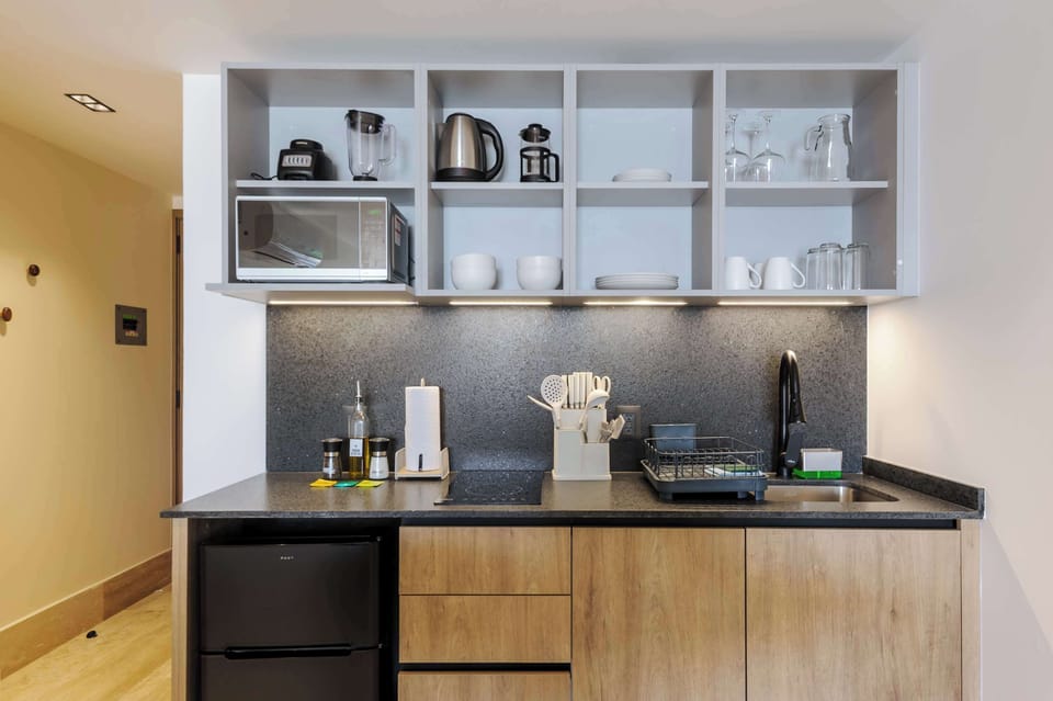 Compact kitchen setup with essential appliances and utensils.