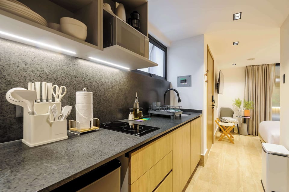 Long kitchen counter with storage and lighting.