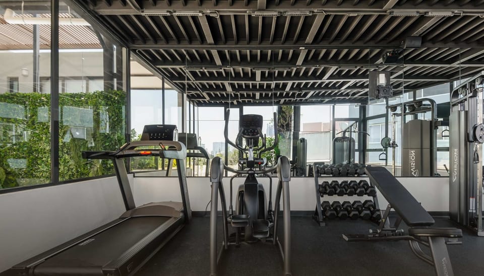 Spacious gym area with treadmills and training equipment.