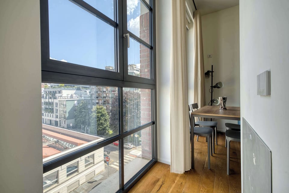 Bright corner with floor-to-ceiling windows and city views.
