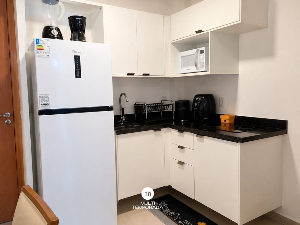 Premium Apartment, Pool Access | Private kitchen | Microwave, cookware/dishes/utensils, dining table