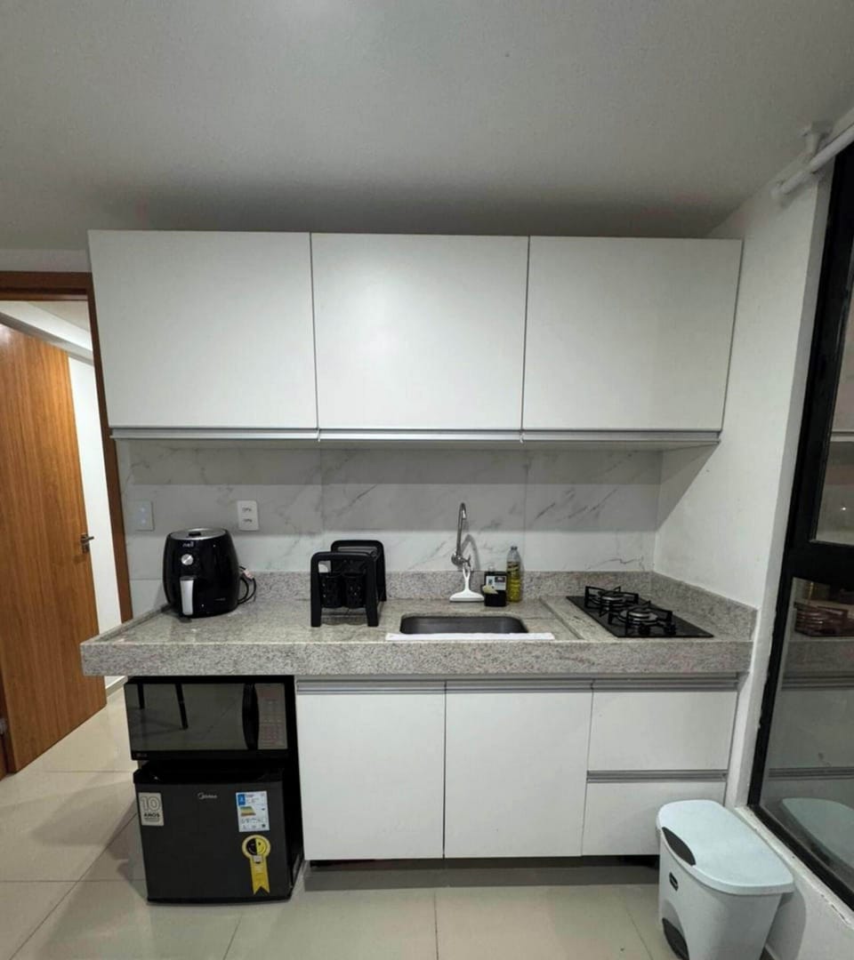 Deluxe Apartment, Pool Access, Sea View | Private kitchen | Fridge, microwave, cookware/dishes/utensils, dining tables