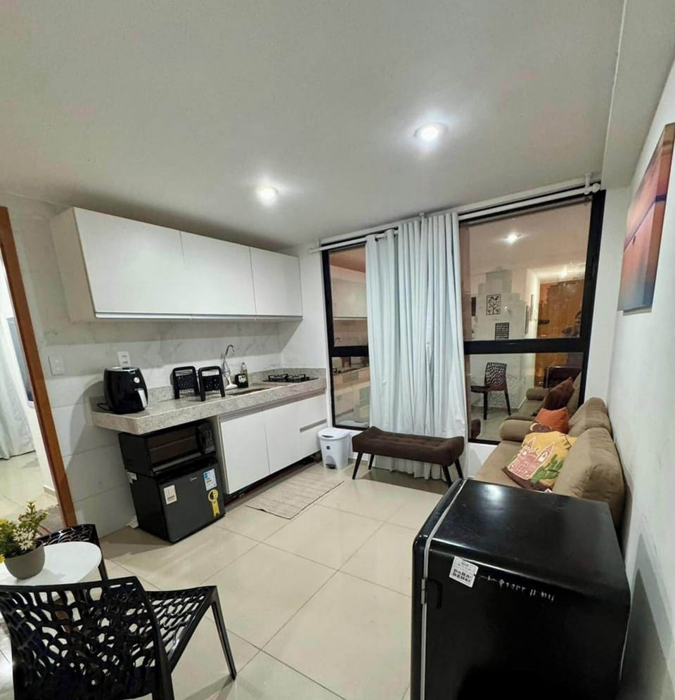 Deluxe Apartment, Pool Access, Sea View | Private kitchen | Fridge, microwave, cookware/dishes/utensils, dining tables