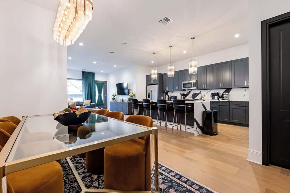 Living, dining, and kitchen area. Fully stocked kitchen. Table seating for six, counter seating for four, queen-size sleeper sofa. Enter suite directly from sidewalk.