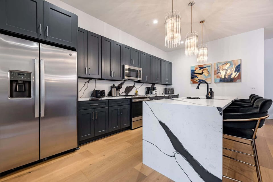 Fully stocked kitchen. Island with counter seating for four.