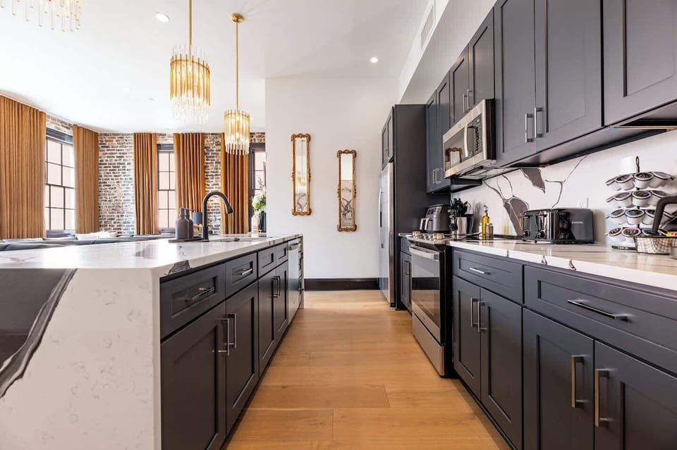 Living, dining, and kitchen area. Fully stocked kitchen. Table seating for six, counter seating for four, queen-size sleeper sofa.