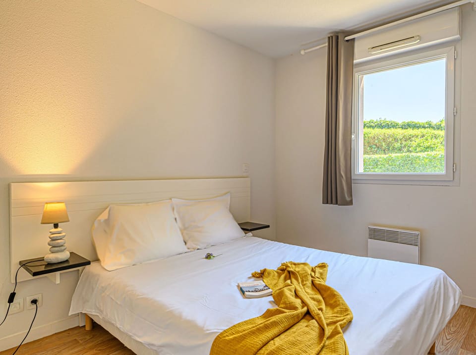 Relax on the double bed, draped in soft linens with gentle light filling the separate bedroom.