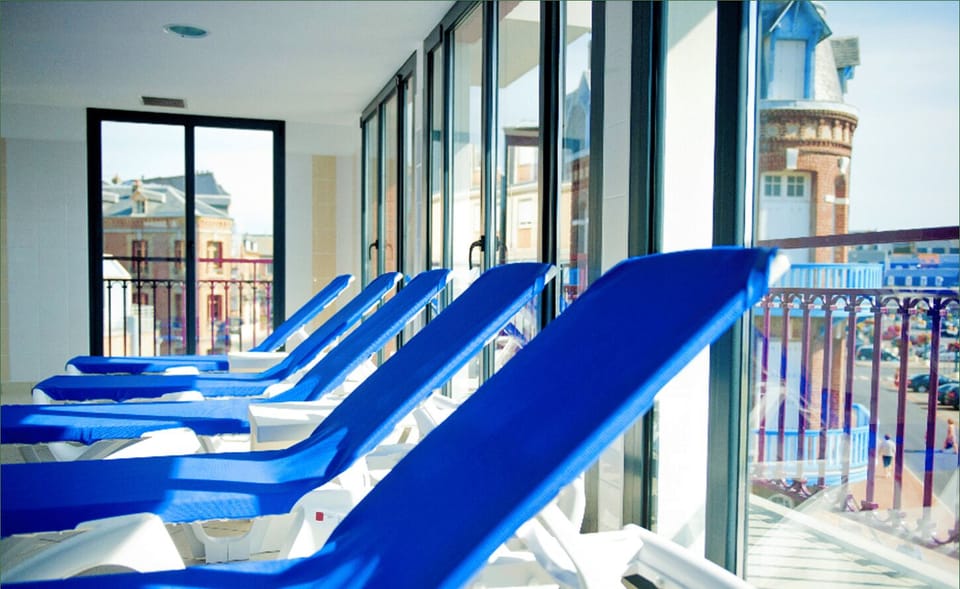 Relax on lounge chairs overlooking the indoor pool, a peaceful retreat after a morning at the beach