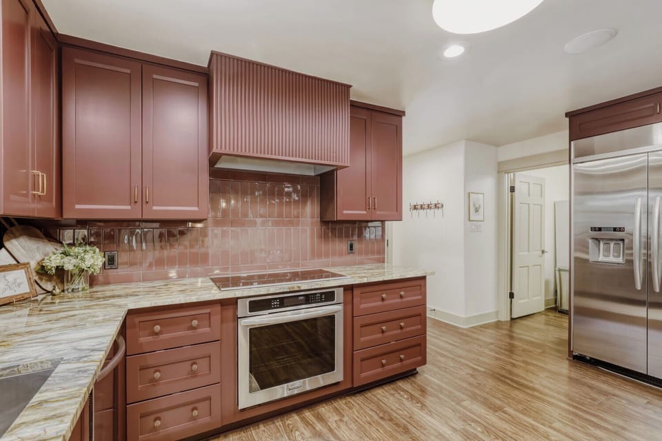 Spacious chef’s kitchen featuring custom finishes, stainless appliances, and plenty of room to cook and connect