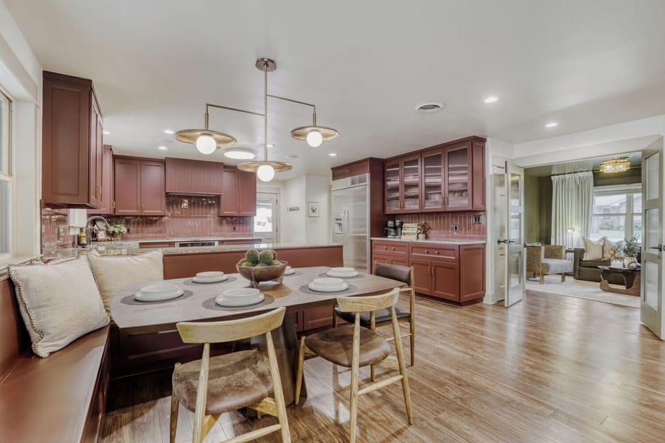 Warm, inviting kitchen with rich cabinetry and a cozy dining nook, perfect for gathering and entertaining