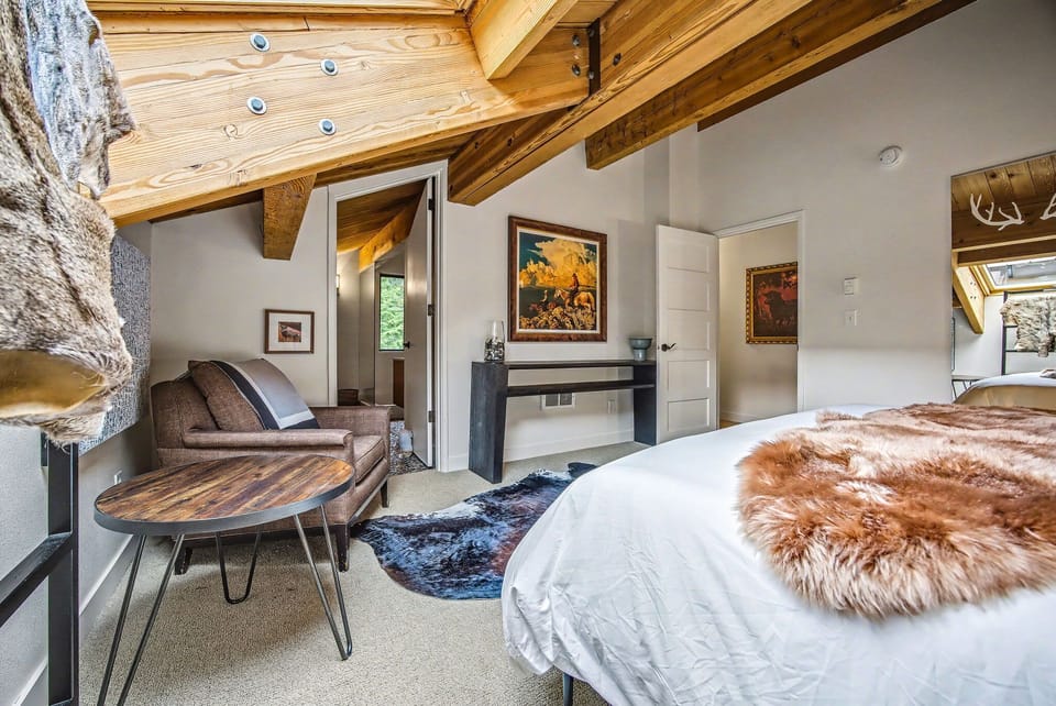 Sunlit guest room featuring comfortable seating and charming rustic decor for peaceful relaxation.