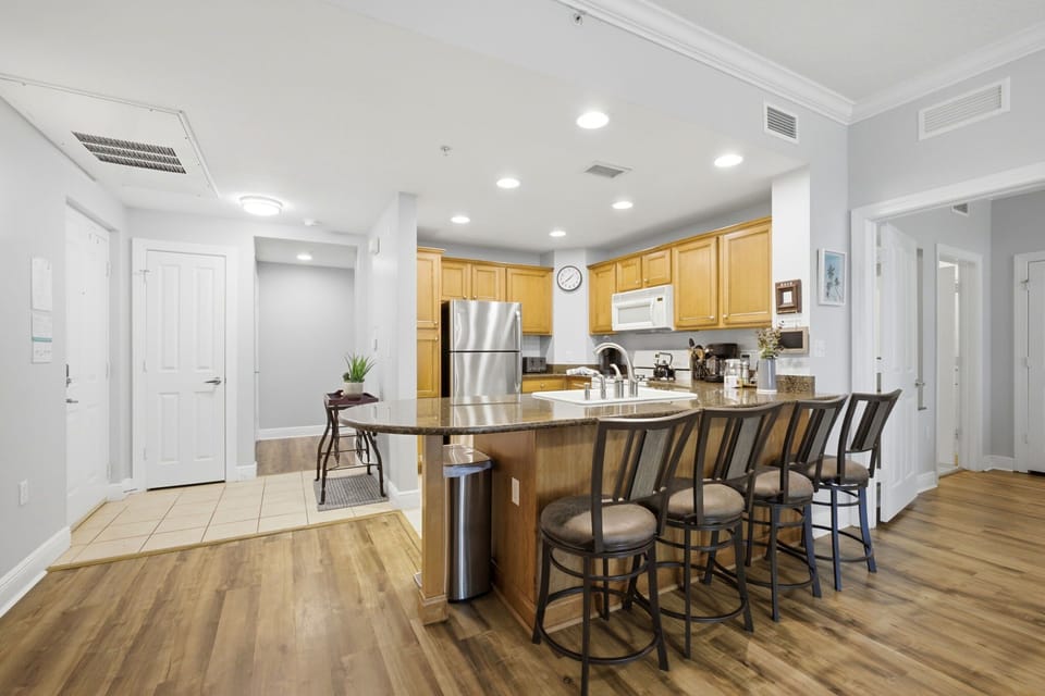 Fully equipped kitchen with bar seating for casual meals