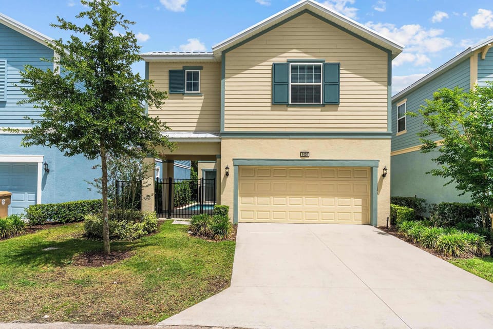 Modern two-story house with a gated pool area and attached garage