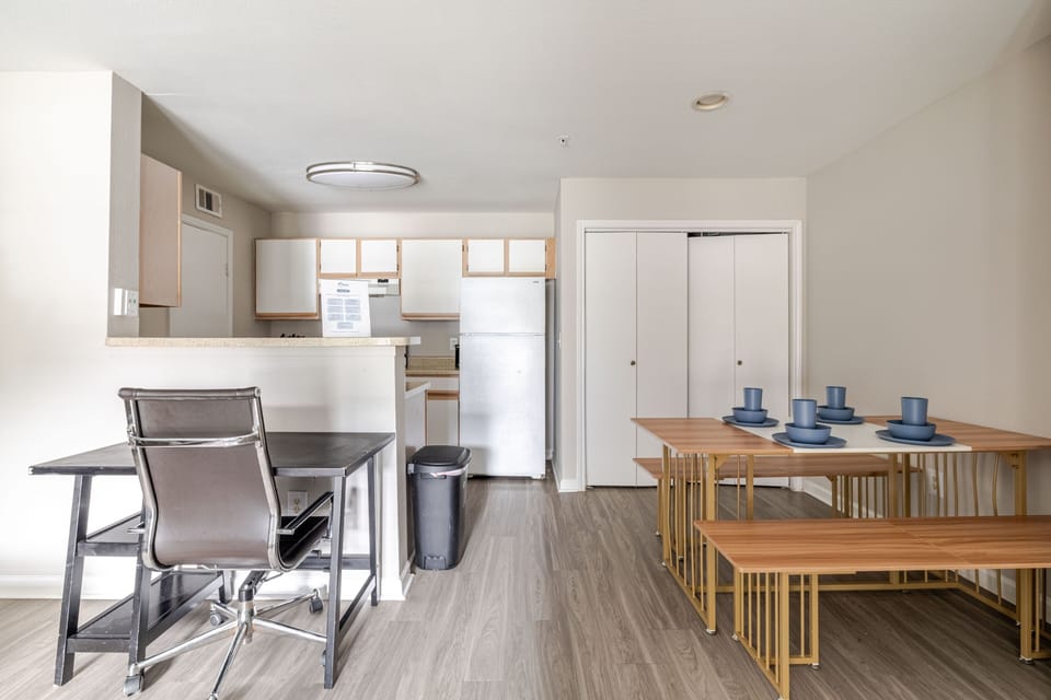 Bright open dining area with breakfast bar, workspace, and modern seating
